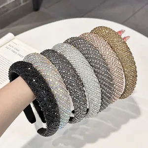 Close-up of padded velvet headbands with sparkling rhinestones in various colors