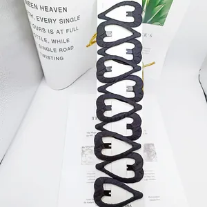 Set of 10 black heart-shaped hair clips with fabric texture on a white display card