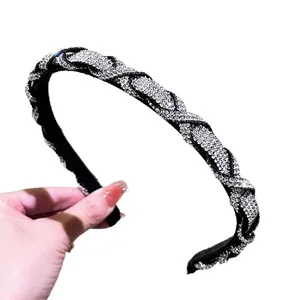 Sparkling braided headband for women with silver rhinestones on black woven fabric