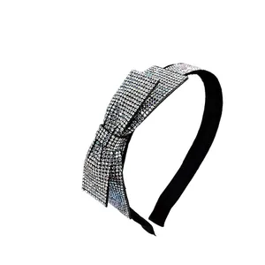 Sparkling crystal bow headband with silver rhinestones on a slim black metal band