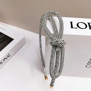 Elegant silver sparkling rhinestone bow headband with a flexible metal base for women
