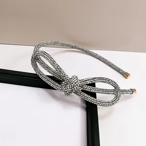 Elegant silver rhinestone headband with a large layered bow design for women