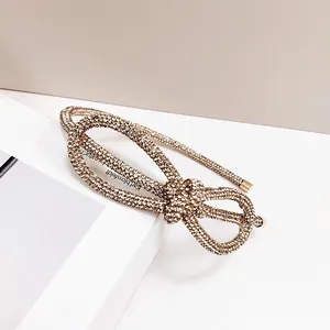 Macro shot of gold headband featuring intricate champagne crystal bow detail