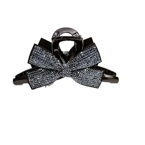 Grande pince à cheveux élégante avec nœud en strass bleus et base noire polie