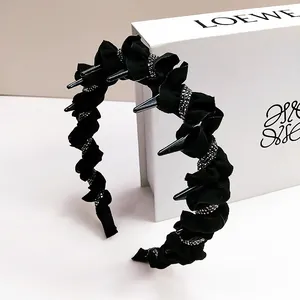 Black pleated headband with metallic studs and rhinestones for a gothic punk aesthetic