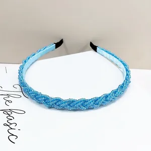 Primer plano de diadema trenzada de cuentas azul claro con textura de cristal