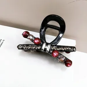Κομψό μαύρο κλάμερ μαλλιών με φιόγκο, μπορντό χάντρες και λαμπερά στρας