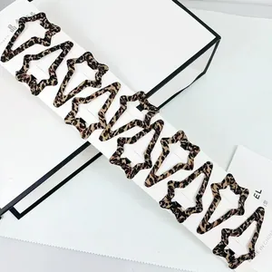 Set of 10 star-shaped leopard print hair clips displayed on a white product card