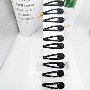 Set of 10 black fabric BB hair clips with colorful rhinestones on a display card