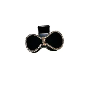 Pinza para el pelo con lazo negro elegante y diamantes de imitación blancos brillantes