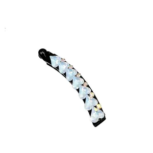 Elegant banana hair clip with blue heart-shaped crystals and sparkling rhinestones