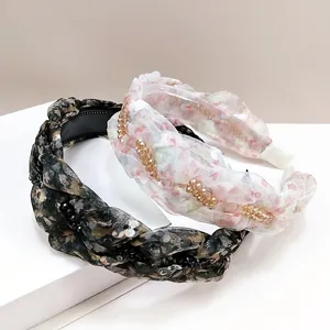 Detail of twisted floral headband with crystal beads and anti-slip comb teeth design