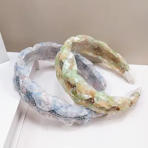 Detail of floral fabric headbands with delicate handmade beads and inner non-slip combs