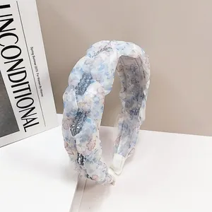 Chic light blue floral crystal headband with padded design and silver bead accents