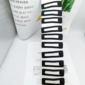 Detail of 10-piece matte black fabric-wrapped rectangular hair clips on display card