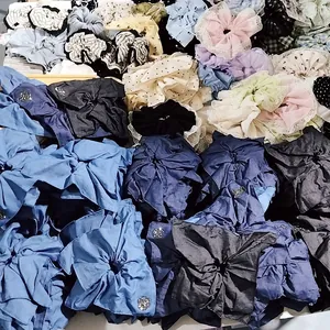 Close-up of assorted oversized denim and lace hair scrunchies with pearl embellishments
