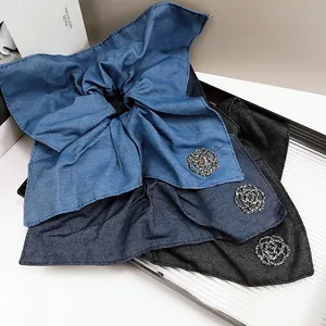 Detail of denim fabric hair scrunchies with elegant white rhinestone rose flower patterns