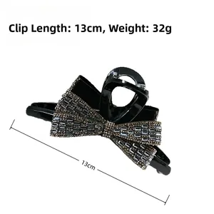 Detail view of 13cm black bow hair claw clip with rhinestones, 32g lightweight design