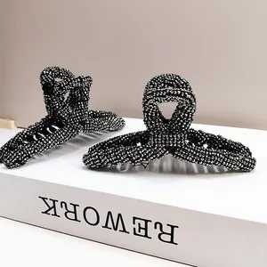 Elegant large shark hair claw clip with sparkly rhinestones on a black base for women