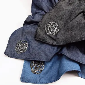 Close-up of denim scrunchies with sparkling rhinestone camellia flower details