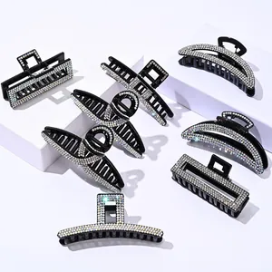 Set of black hair claw clips with rainbow rhinestones in various geometric shapes
