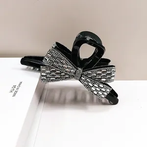 Sparkling rhinestone bow hair claw clip in black with silver crystals for women