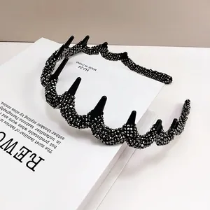Detail of wavy black headband with silver rhinestones and anti-slip teeth design