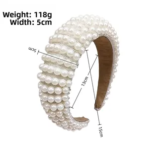 Detail of wide padded headband featuring woven white pearls and measurement specs