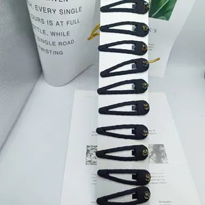 Set of 10 black fabric BB hair clips with colorful rhinestones on a display card