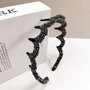 Detail of black wavy headband with sparkling rhinestones and anti-slip teeth for secure grip