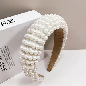 Detail of wide sponge headband with white pearls and brown velvet lining