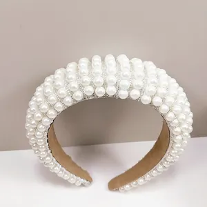 Detailed view of handmade baroque headband with white pearls and beige suede lining