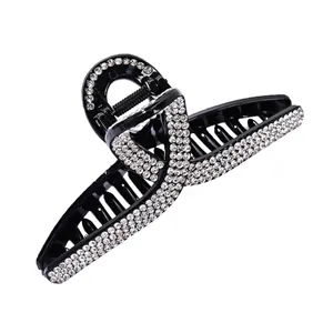 Elegant black hair claw clip with sparkling rhinestones for women's sophisticated hair styling
