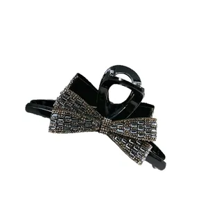 Sparkling bow hair claw clip with silver rhinestones and glossy black finish