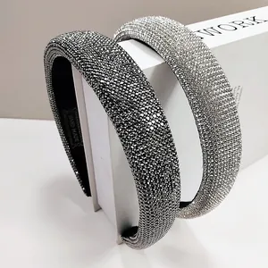 Detail of handmade padded headband with sparkling crystal rhinestones and woven logo tag