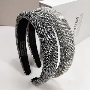 Macro detail of luxury full rhinestone headband with gold HAND MADE lettering on inner lining