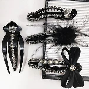 Elegant 4-piece black hair clip set with rhinestones, pearls, bow and feathers