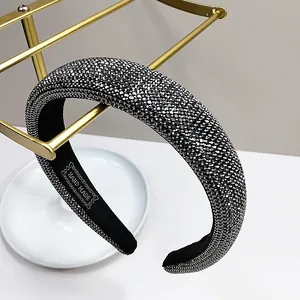 Detail of handcrafted rhinestone headband with hand made label on black lining