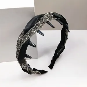 Detailansicht eines schwarzen Satin-Haarreifs mit Strasssteinen und kleinen Haarklammern