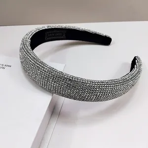 Detailed macro view of silver rhinestone headband with black lining and handmade label