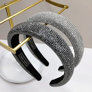 Macro view of crystal rhinestones on wide headbands with handmade tag and black velvet lining