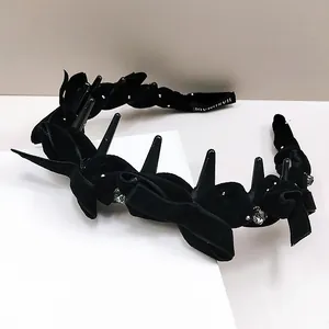 Detail of black velvet headband with sparkling rhinestones and handmade inner teeth