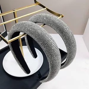Detail view of silver padded headband with sparkling rhinestones on golden stand