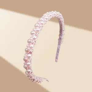 Close-up of pink luxury handmade faux pearl headband with layered bead textures
