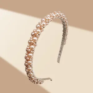 Detailed close-up of champagne pearl headband showing intricate beadwork and fabric lining