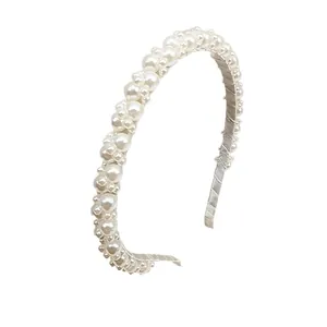 Luxurious handmade faux pearl headband with elegant layered beads on a satin base