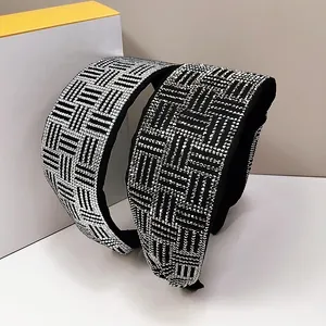 Close-up of wide rhinestone headband with silver crystal geometric weaving patterns