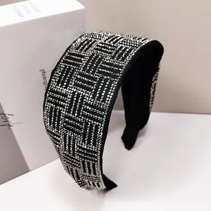 Detail of wide black headband with shimmering silver rhinestones in a geometric pattern