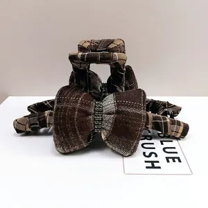 Close-up of brown plaid fabric hair claw clip featuring sparkling silver rhinestones