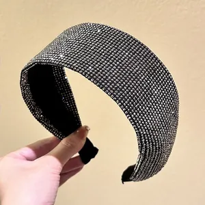 Close-up of a wide padded headband featuring sparkling full crystal rhinestones